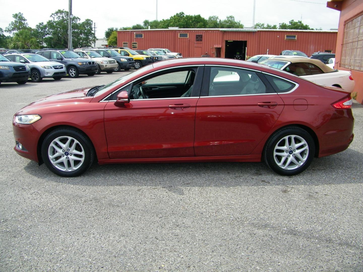 2014 Orange /Black Ford Fusion SE (3FA6P0HD7ER) with an 1.5L L4 DOHC 16V engine, Automatic transmission, located at 4000 Bee Ridge Road, Sarasota, FL, 34233, (941) 926-0300, 27.298664, -82.489151 - Photo#2